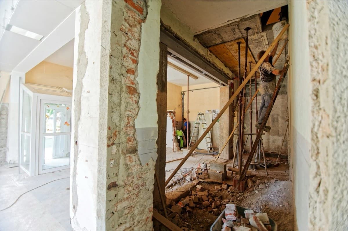Interior renovation in progress with debris ready for cleanup