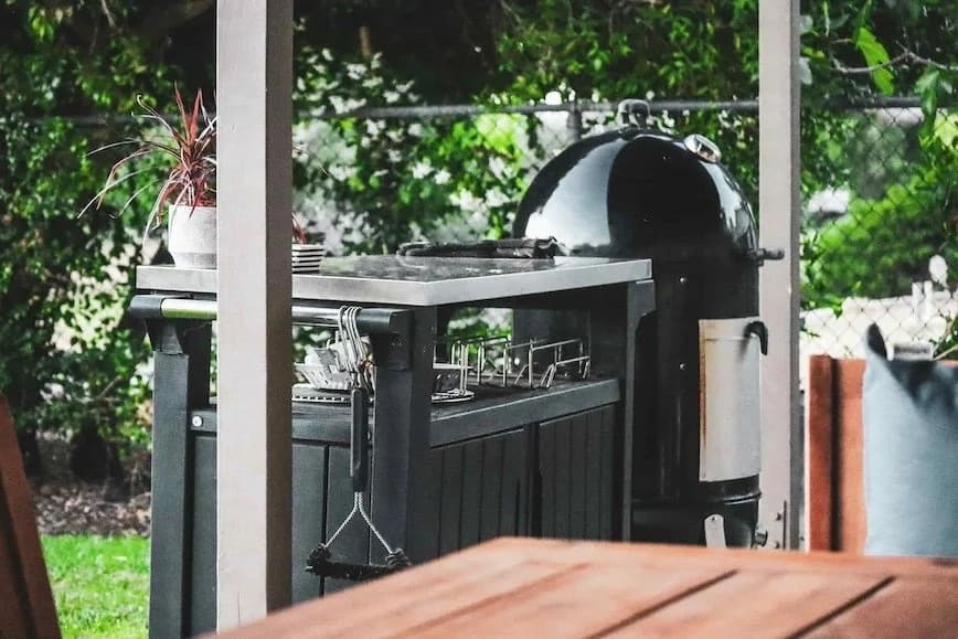 Backyard outdoor kitchen and grill station under a pergola