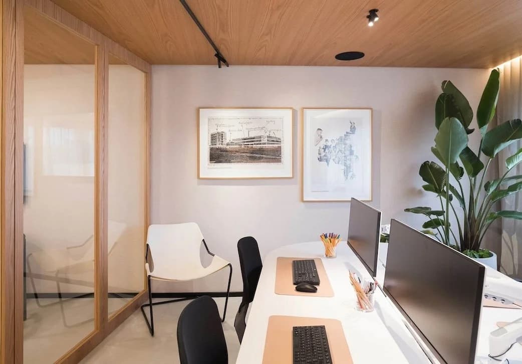 Clean, modern office workspace with tidy desks and monitors