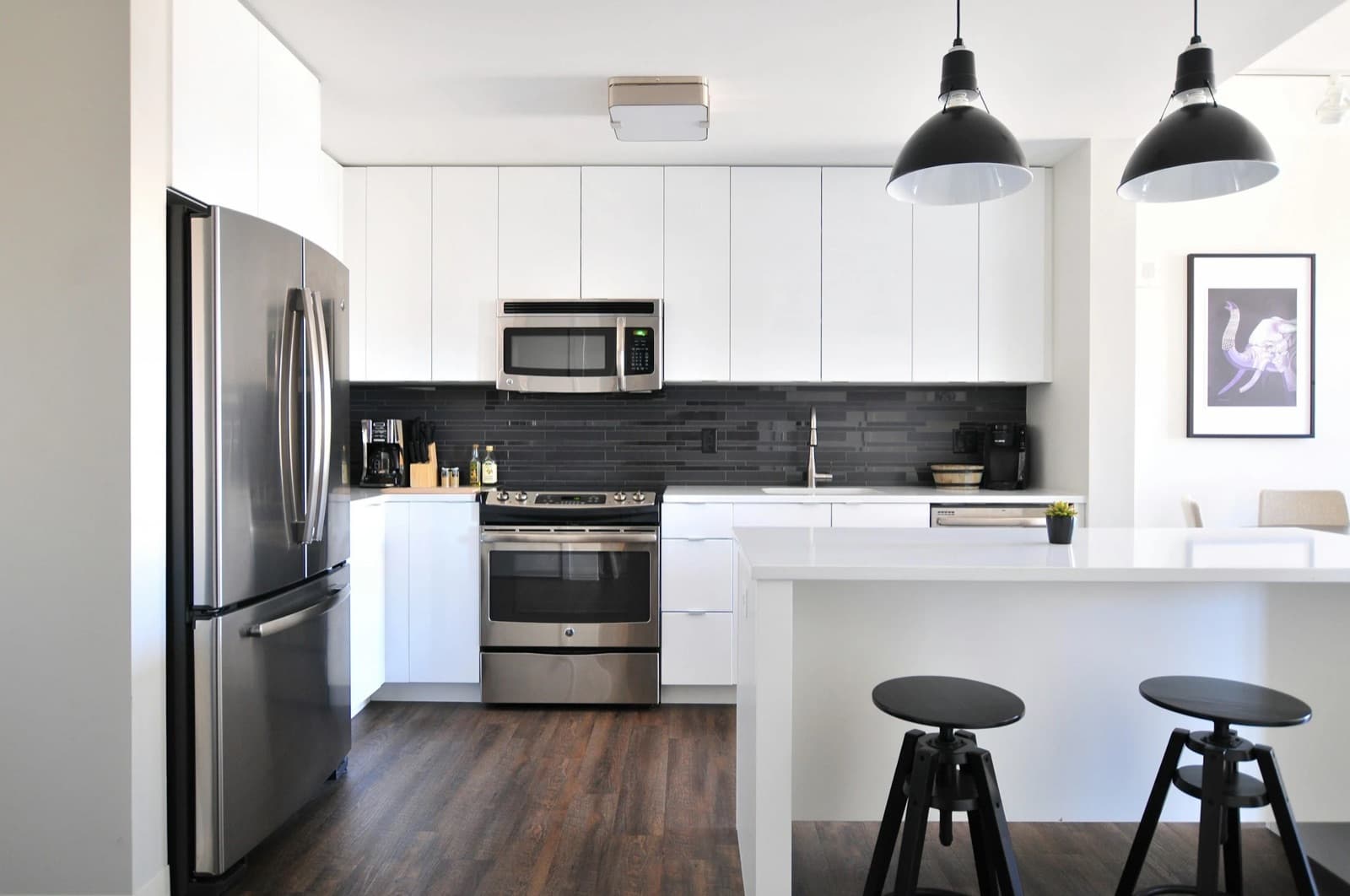 Spotless modern kitchen with white cabinets and polished counters