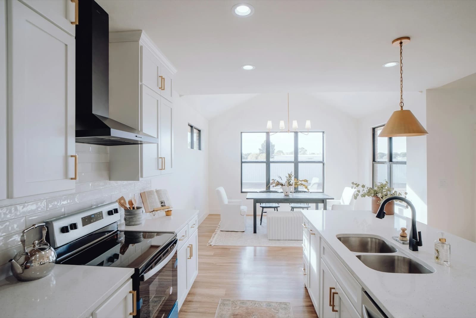 Bright, freshly cleaned white kitchen and dining area in a modern home